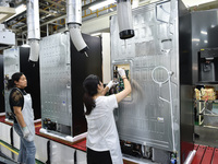 Workers are assembling refrigerators at the LG Refrigerator production base in Taizhou, China, on May 23, 2024. This is LG's largest refrige...