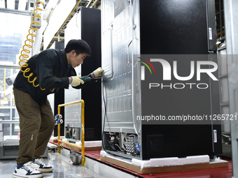 Workers are assembling refrigerators at the LG Refrigerator production base in Taizhou, China, on May 23, 2024. This is LG's largest refrige...