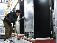 Workers are assembling refrigerators at the LG Refrigerator production base in Taizhou, China, on May 23, 2024. This is LG's largest refrige...