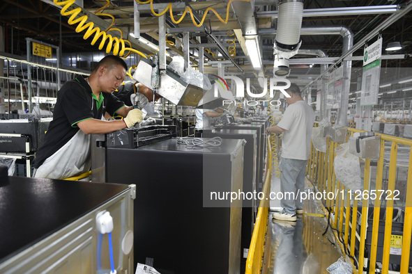 Workers are assembling refrigerators at the LG Refrigerator production base in Taizhou, China, on May 23, 2024. This is LG's largest refrige...