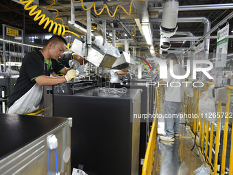 Workers are assembling refrigerators at the LG Refrigerator production base in Taizhou, China, on May 23, 2024. This is LG's largest refrige...