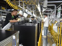 Workers are assembling refrigerators at the LG Refrigerator production base in Taizhou, China, on May 23, 2024. This is LG's largest refrige...