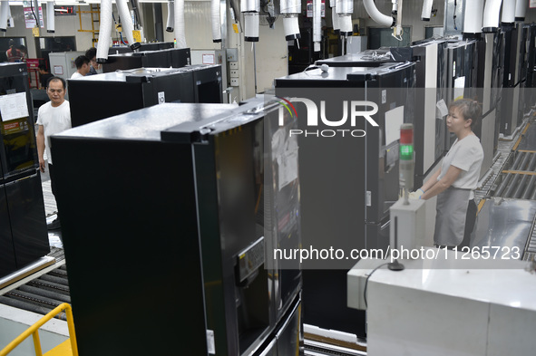 Workers are assembling refrigerators at the LG Refrigerator production base in Taizhou, China, on May 23, 2024. This is LG's largest refrige...