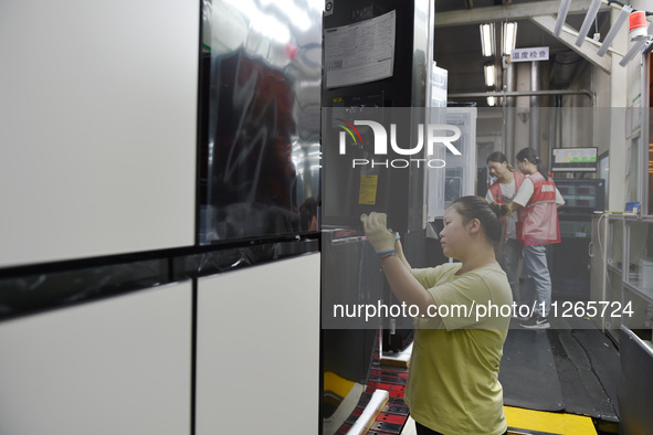 Workers are assembling refrigerators at the LG Refrigerator production base in Taizhou, China, on May 23, 2024. This is LG's largest refrige...