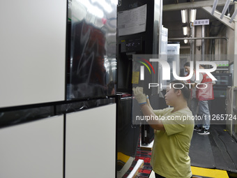 Workers are assembling refrigerators at the LG Refrigerator production base in Taizhou, China, on May 23, 2024. This is LG's largest refrige...