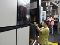 Workers are assembling refrigerators at the LG Refrigerator production base in Taizhou, China, on May 23, 2024. This is LG's largest refrige...