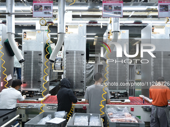 Workers are assembling refrigerators at the LG Refrigerator production base in Taizhou, China, on May 23, 2024. This is LG's largest refrige...