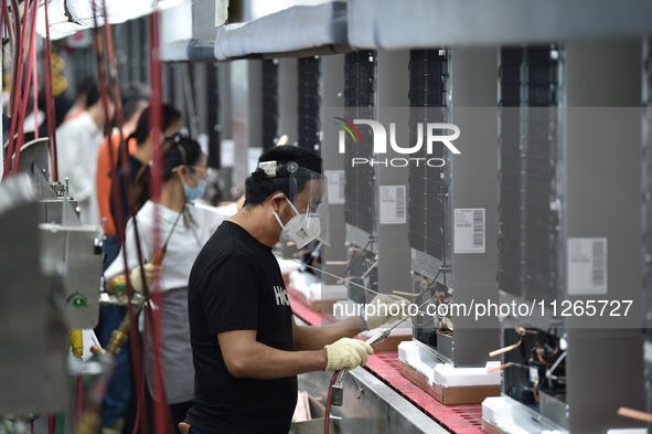 Workers are assembling refrigerators at the LG Refrigerator production base in Taizhou, China, on May 23, 2024. This is LG's largest refrige...