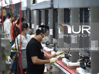 Workers are assembling refrigerators at the LG Refrigerator production base in Taizhou, China, on May 23, 2024. This is LG's largest refrige...