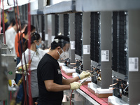 Workers are assembling refrigerators at the LG Refrigerator production base in Taizhou, China, on May 23, 2024. This is LG's largest refrige...