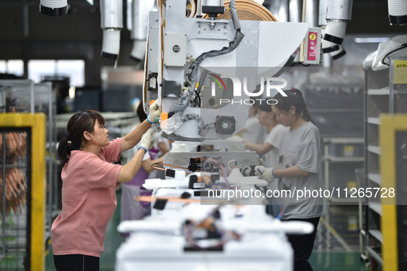 Workers are assembling refrigerators at the LG Refrigerator production base in Taizhou, China, on May 23, 2024. This is LG's largest refrige...