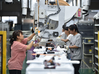 Workers are assembling refrigerators at the LG Refrigerator production base in Taizhou, China, on May 23, 2024. This is LG's largest refrige...