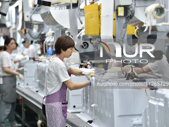 Workers are assembling refrigerators at the LG Refrigerator production base in Taizhou, China, on May 23, 2024. This is LG's largest refrige...