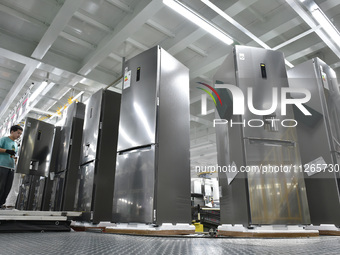 Workers are assembling refrigerators at the LG Refrigerator production base in Taizhou, China, on May 23, 2024. This is LG's largest refrige...