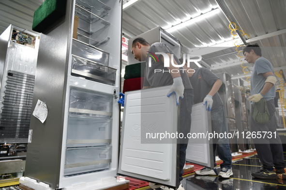 Workers are assembling refrigerators at the LG Refrigerator production base in Taizhou, China, on May 23, 2024. This is LG's largest refrige...