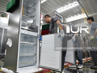 Workers are assembling refrigerators at the LG Refrigerator production base in Taizhou, China, on May 23, 2024. This is LG's largest refrige...