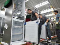 Workers are assembling refrigerators at the LG Refrigerator production base in Taizhou, China, on May 23, 2024. This is LG's largest refrige...