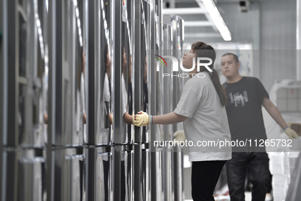 Workers are assembling refrigerators at the LG Refrigerator production base in Taizhou, China, on May 23, 2024. This is LG's largest refrige...