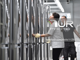 Workers are assembling refrigerators at the LG Refrigerator production base in Taizhou, China, on May 23, 2024. This is LG's largest refrige...