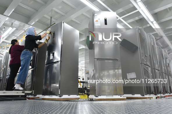 Workers are assembling refrigerators at the LG Refrigerator production base in Taizhou, China, on May 23, 2024. This is LG's largest refrige...