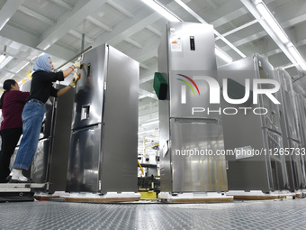 Workers are assembling refrigerators at the LG Refrigerator production base in Taizhou, China, on May 23, 2024. This is LG's largest refrige...