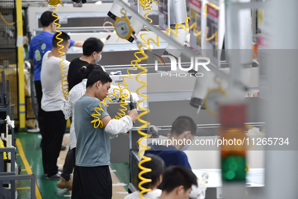 Workers are assembling refrigerators at the LG Refrigerator production base in Taizhou, China, on May 23, 2024. This is LG's largest refrige...