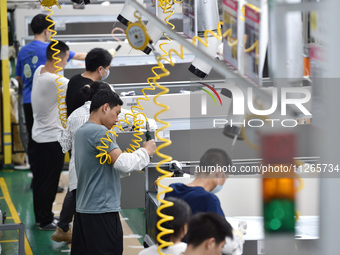 Workers are assembling refrigerators at the LG Refrigerator production base in Taizhou, China, on May 23, 2024. This is LG's largest refrige...