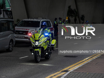 Police officers are riding motorbikes outside the courthouse where the trial of Jimmy Lai, the founder of the now-shuttered Apple Daily News...