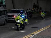 Police officers are riding motorbikes outside the courthouse where the trial of Jimmy Lai, the founder of the now-shuttered Apple Daily News...