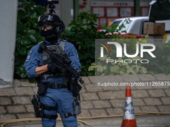 A police officer is standing guard outside the courthouse where the trial of Jimmy Lai, the founder of the now-shuttered Apple Daily Newspap...