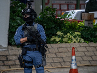 A police officer is standing guard outside the courthouse where the trial of Jimmy Lai, the founder of the now-shuttered Apple Daily Newspap...