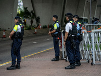 Police officers are standing guard at the courthouse where the trial of Jimmy Lai, the founder of the now-shuttered Apple Daily Newspaper, i...