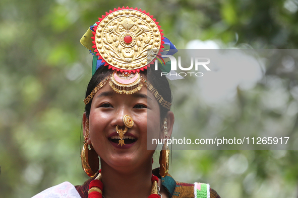 A Nepalese girl from the Kirat community is wearing traditional attire during the Ubhauli festival in Lalitpur, Nepal, on May 23, 2024. 