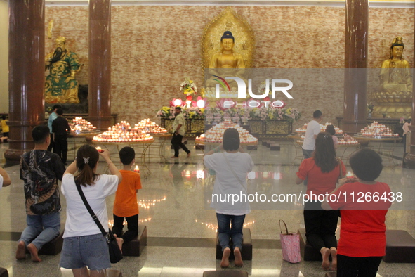 Buddhists are worshipping Buddha statues to carry out worship and prayers to coincide with Vesak Day 2024 at Maha Vihara Maitreya, Medan Est...