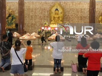 Buddhists are worshipping Buddha statues to carry out worship and prayers to coincide with Vesak Day 2024 at Maha Vihara Maitreya, Medan Est...