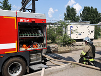 A firefighter is staying by a fire engine during a response effort to a Russian S-300 missile strike on a printing company in Kharkiv, Ukrai...