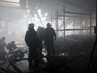 Firefighters are working during a response effort to a Russian S-300 missile strike on a printing company in Kharkiv, Ukraine, on May 23, 20...