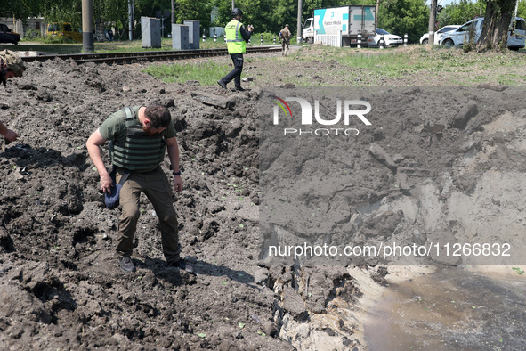 A forensic expert is working at the crater of a projectile during a response effort to a Russian S-300 missile strike on a printing company...