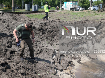 A forensic expert is working at the crater of a projectile during a response effort to a Russian S-300 missile strike on a printing company...