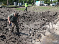 A forensic expert is working at the crater of a projectile during a response effort to a Russian S-300 missile strike on a printing company...