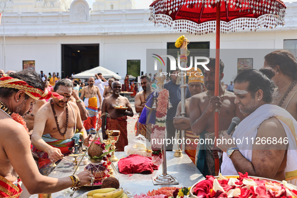 Hindu priests are reciting prayers as Tamil Hindu devotees are taking part in the chariot procession (ther) during the Ganesha Mahotshava Vi...