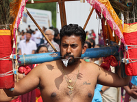 Tamil Hindu devotees are performing the Kavadi Attam dance as devotees are taking part in the chariot procession (ther) during the Ganesha M...