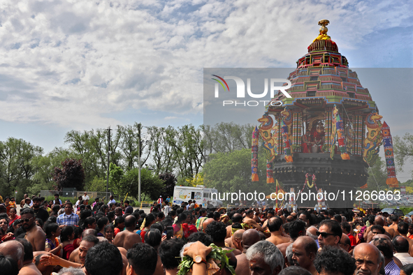 Tamil Hindu devotees are taking part in the chariot procession (ther) during the Ganesha Mahotshava Vingnapanam Festival at the Ganesh Templ...