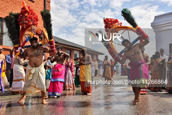 Tamil Hindu devotees are performing the Kavadi Attam dance as devotees are taking part in the chariot procession (ther) during the Ganesha M...