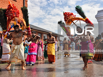 Tamil Hindu devotees are performing the Kavadi Attam dance as devotees are taking part in the chariot procession (ther) during the Ganesha M...