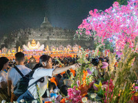 Devotees are using umbrellas for shelter during the Vesak celebration at Borobudur Temple. Despite the rainfall, their spirits are remaining...