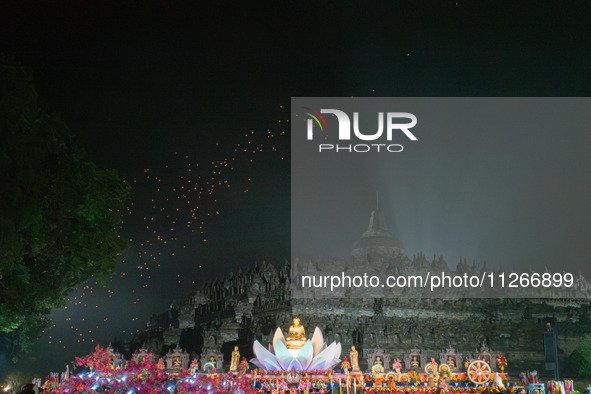 Thousands of lanterns are illuminating the night sky above Borobudur Temple, creating a breathtaking view. Each lantern is symbolizing hope...