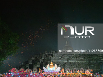 Thousands of lanterns are illuminating the night sky above Borobudur Temple, creating a breathtaking view. Each lantern is symbolizing hope...