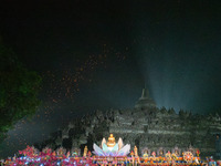 Thousands of lanterns are illuminating the night sky above Borobudur Temple, creating a breathtaking view. Each lantern is symbolizing hope...