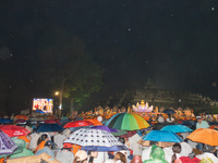 Devotees are using umbrellas for shelter during the Vesak celebration at Borobudur Temple. Despite the rainfall, their spirits are remaining...